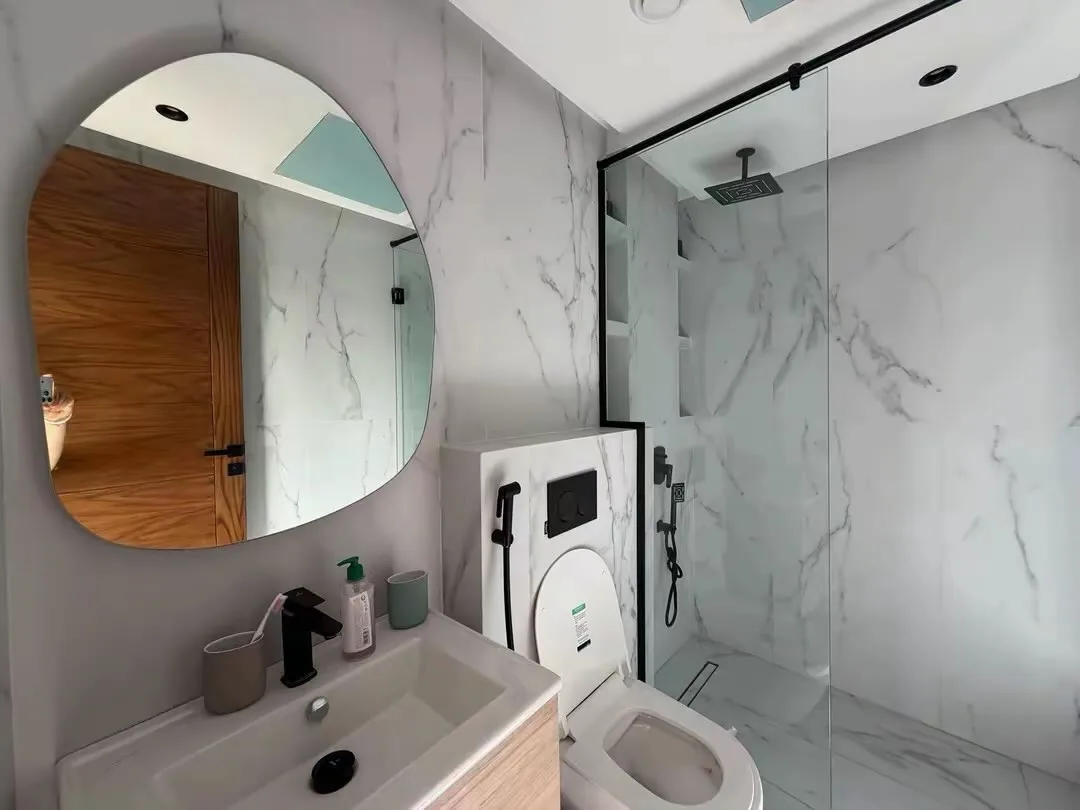 White marble cloakroom, with a glazed shower